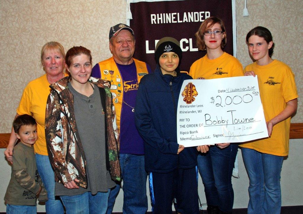 Bobby Towne and his mother were presented with a contribution of $2,000 by Leo Club advisers Jill Zwiers and Dick Garrow, as well as Leo Club members Sammie Kemp and Anna Piasecki.