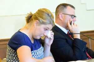 From left, Kaitlyn Juedes, widow of Jacob Juedes, wipes away a team while testifying at Friday's sentencing hearing next to Oneida County district attorney Michael W. Schiek.
