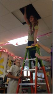Tanner Schmidt, left and Hannah Rumney, on the ladder, work on their egg-cellent science project.