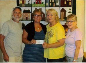 Pictured with the $500 donation from the Community Club are from left, Neal Baudhuin, club president; Tammy Modic, NATH executive director; Kathy Cline, club secretary and Joan Harper, club treasurer. Submitted photo.
