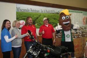 From left, Dana Rady, WPVGA Director of Promotions; Paula Houlihan, President of the Wisconsin Potato Growers Auxiliary; Andy Diercks, President of Coloma Farms in Coloma; Tamas Houlihan, WPVGA Executive Director; and Spudly, WPVGAs mascot.
