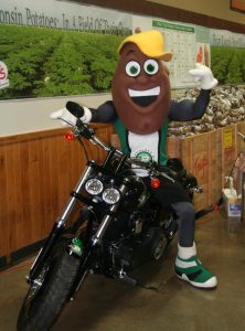 Spudly, the WPVGA mascot tries out the Fat Bob Harley during the award presentation at Trig's in Rhinelander.