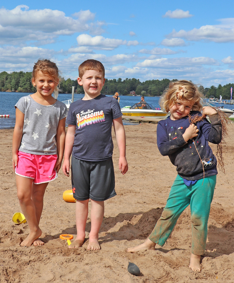 Caroline, William and Ella play in the sand at Torpy Park Beach.