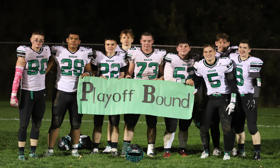 Seniors hold a playoff bound banner after the game.