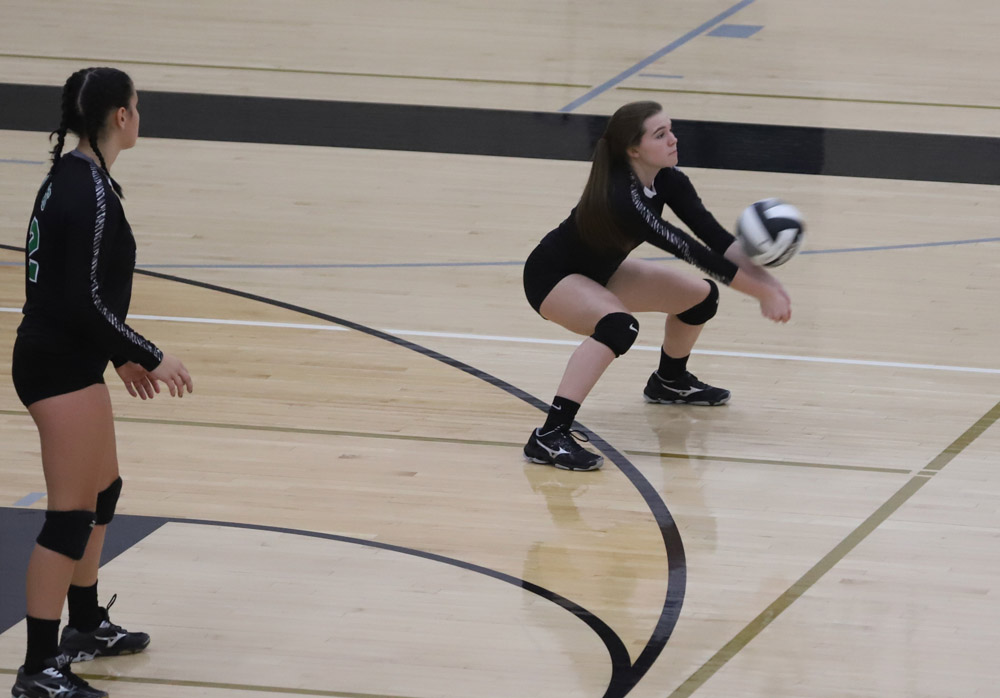Sophomore Carly Schmidt gets low to receive a serve.