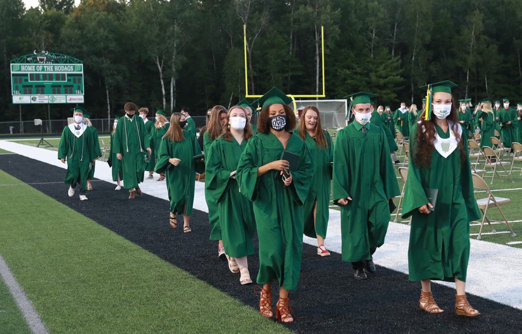 Graduates proceed out of the stadium.