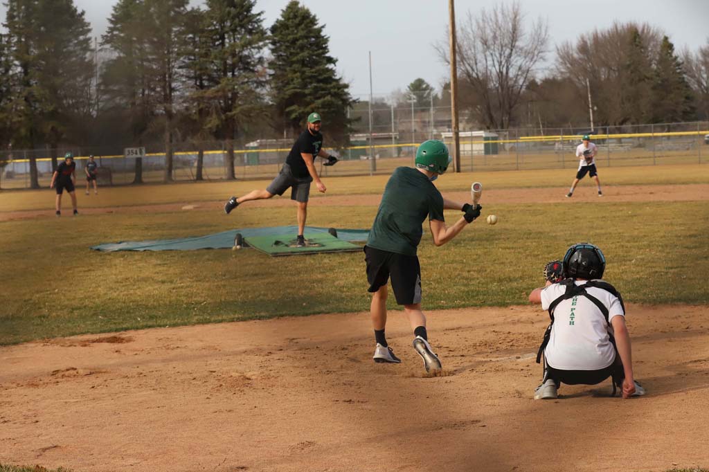 Coach Joe Waksmonski fires a pitch during the mock scrimmage.