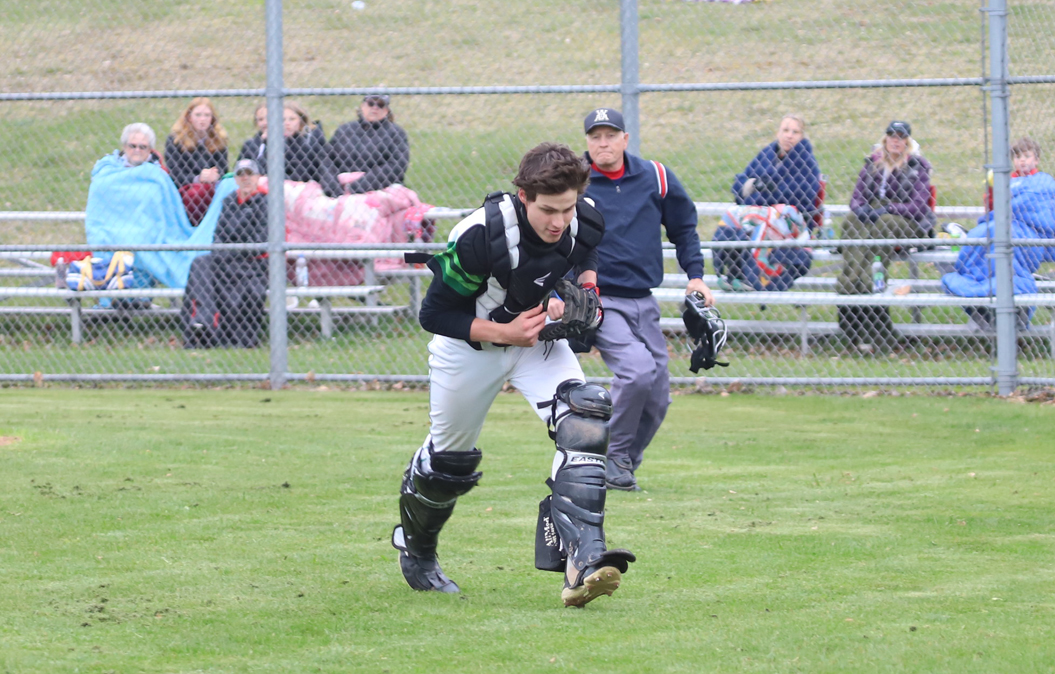 Catcher Joe Schneider makes a running catch to nab a foul ball.