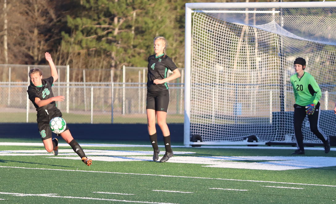 Audrey Schiek heads a shot on goal away from the net.