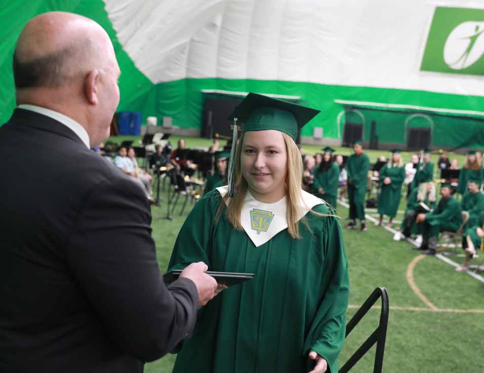 Superintendent of schools Eric Burke handed his daughter Julia her diploma.