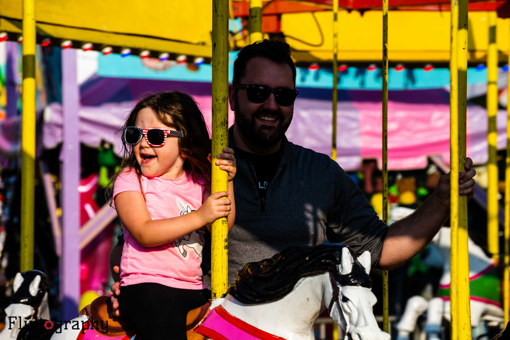 This little girl enjoys the merry-go-round at the Oneida County Fair.
