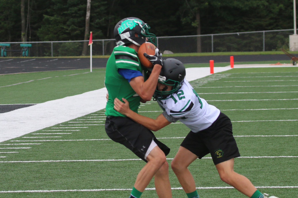 Joe Schneider hauls in a pass and is tackled by Kaleb Winter.