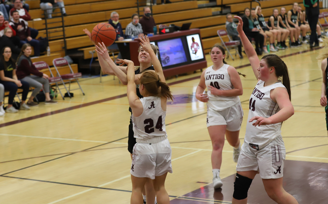 Audrey Schiek is fouled under the basket by Antigo's Neveah Malone.