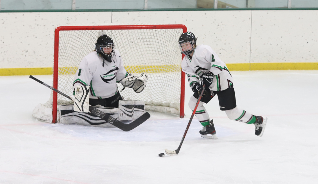 Maddi Roeser clears the puck from in front of the Edge net.