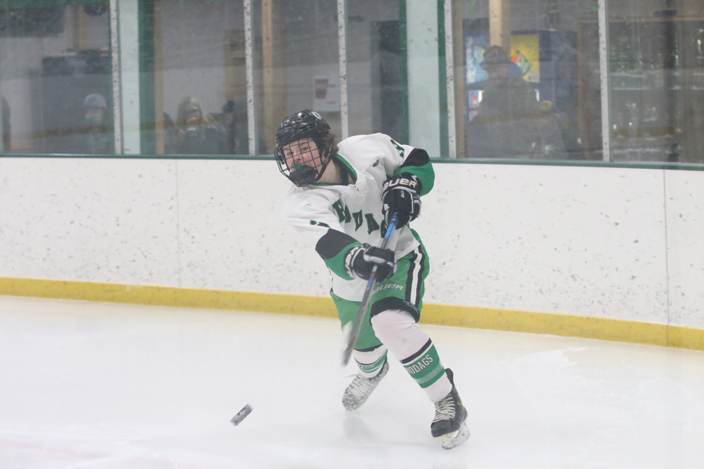 Layne Roeser makes a pass from behind the Hodag net off the boards.