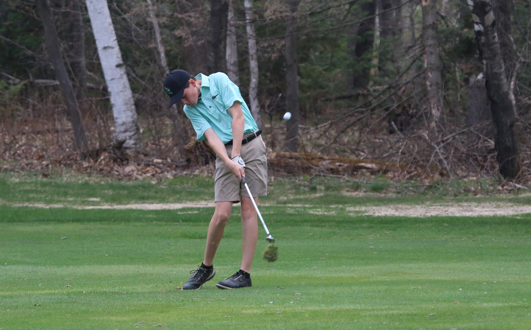 Freshman Brody Kowieski uses an iron on the fairway for a shot.